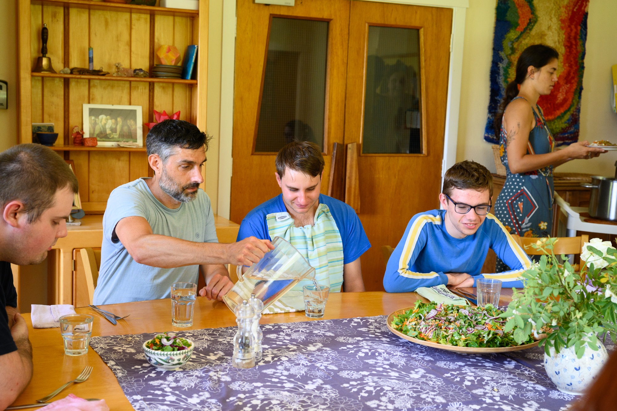 A group of students and coworkers sitting at a table getting ready for lunch