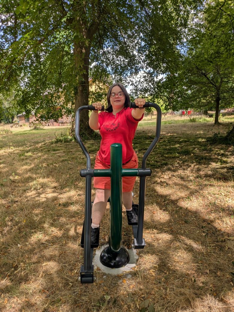 An outdoor exercise machine being used by a co-houser