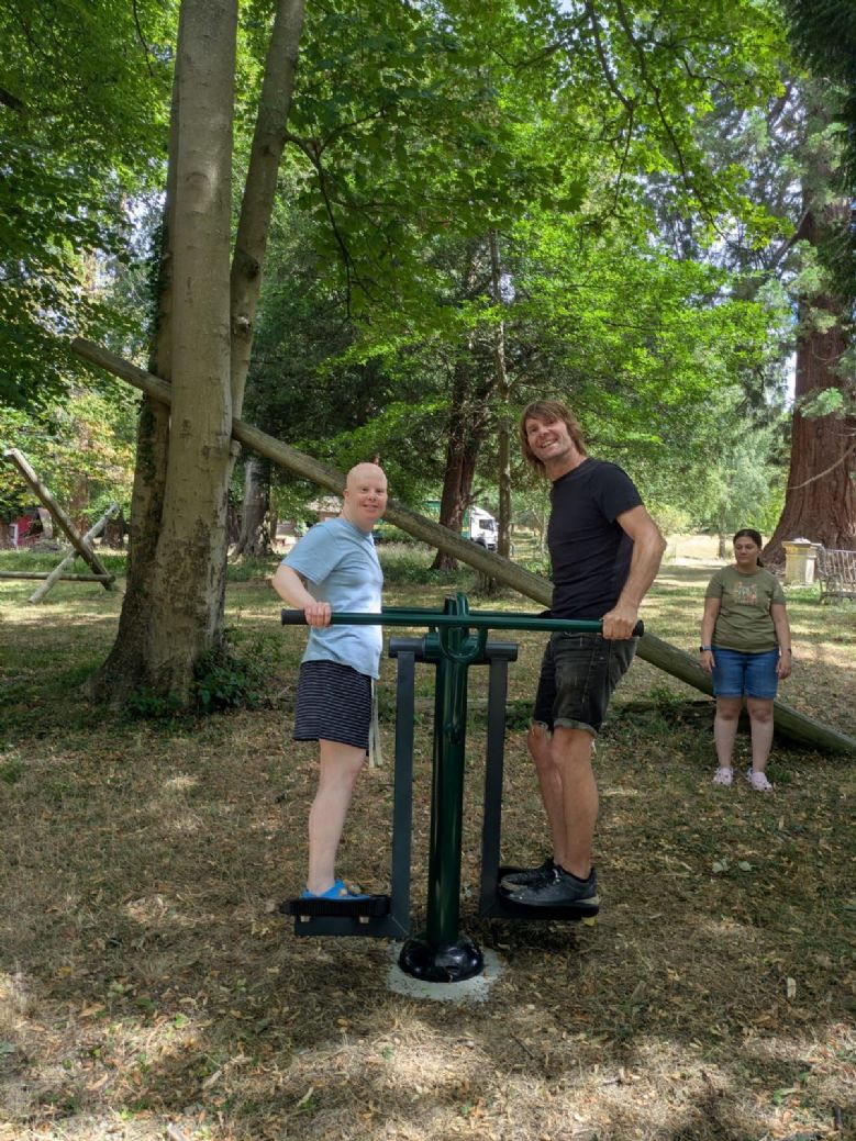 Co-workers and co-housers enjoying the Trim Trail equipment