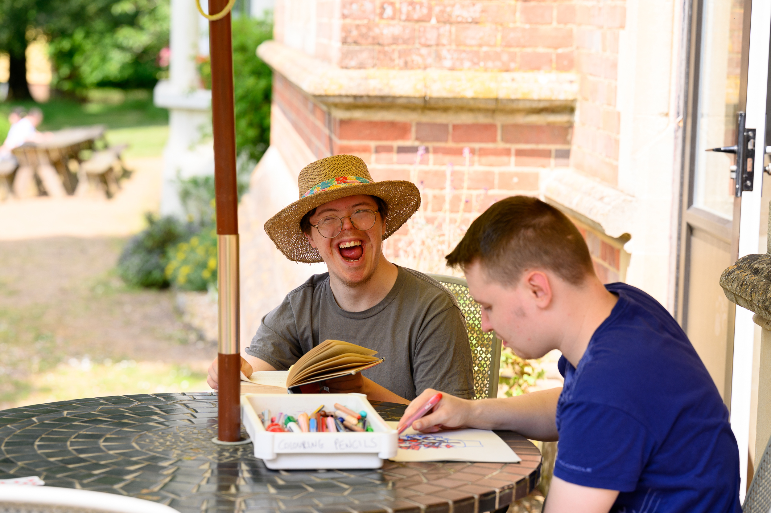 Two students relaxing on the veranda on a summer's day