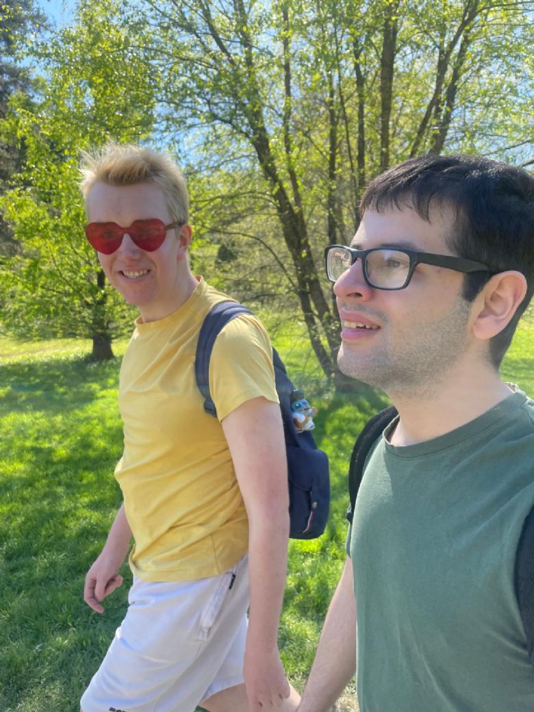 Two people walking in forest