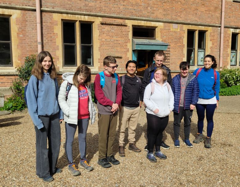 A few students standing in front of a building 