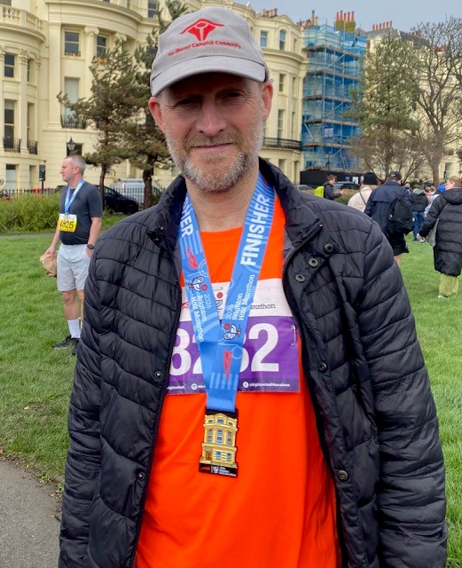 Man wearing half marathon finisher's medal