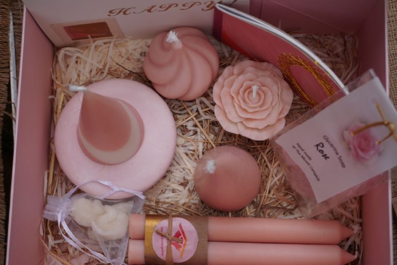 Box of home made crafts in rose