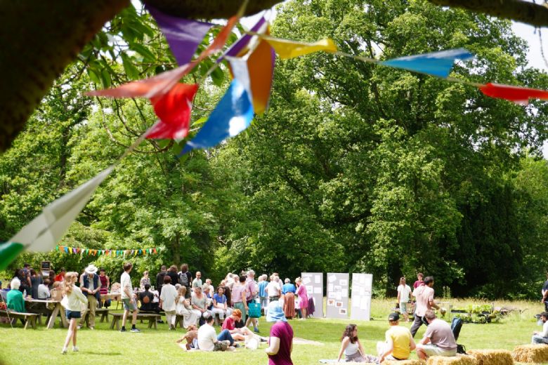 People enjoying festival with flags foreground